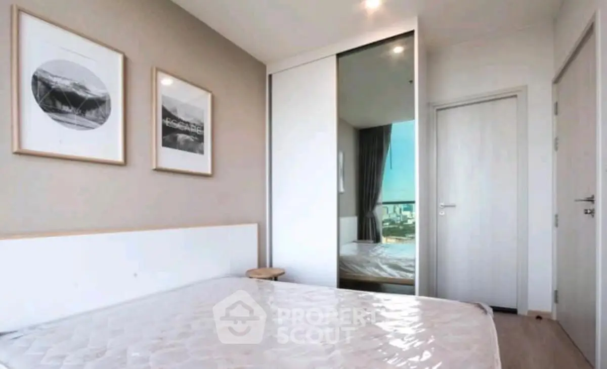 Modern bedroom with minimalist decor and large sliding closet doors
