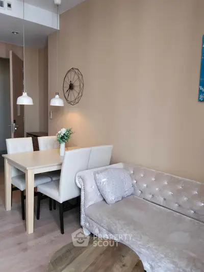 Elegant living room with plush sofa and modern dining set, perfect for stylish urban living.