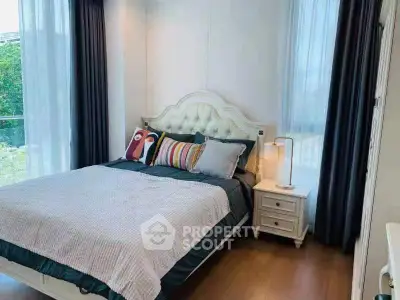 Charming bedroom with elegant decor and large windows offering natural light and serene views.