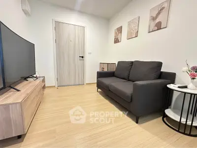Cozy living room with modern decor and comfortable seating in a stylish apartment.