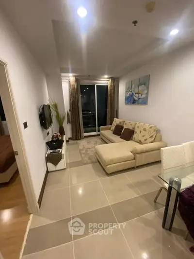 Modern living room with cozy beige sofa and elegant decor in a stylish apartment.