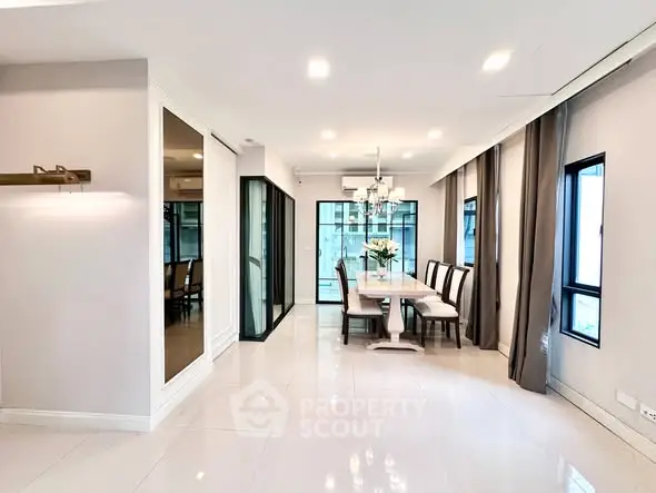 Spacious dining area with modern decor and large windows for natural light.