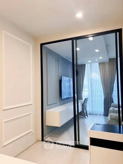 Modern living room with glass partition and elegant decor