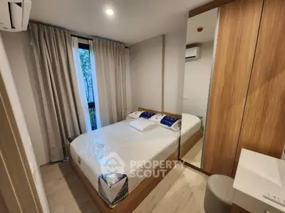 Modern bedroom with mirrored wardrobe and natural light