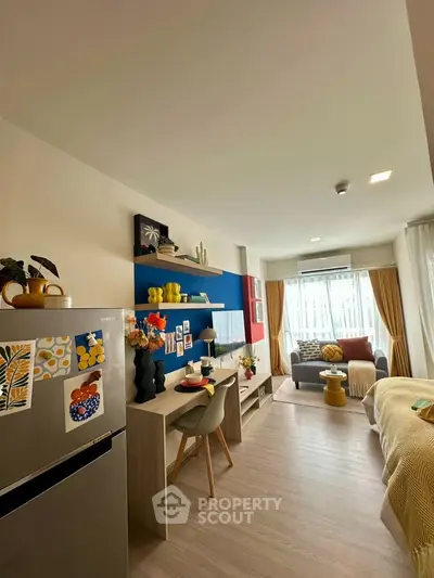 Modern studio apartment with stylish decor and open layout, featuring a cozy living area and workspace.