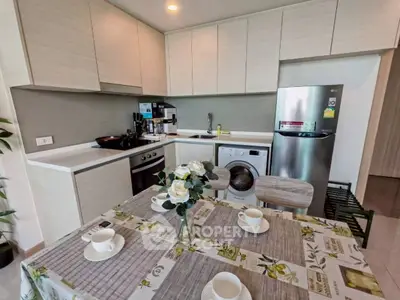 Modern kitchen with sleek appliances and dining area, perfect for culinary enthusiasts.