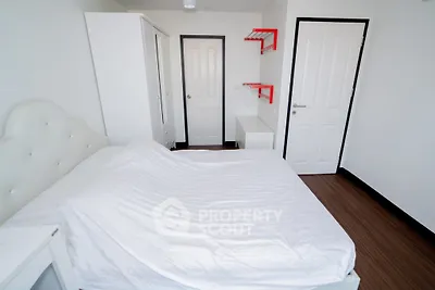 Modern minimalist bedroom with white furniture and red accents