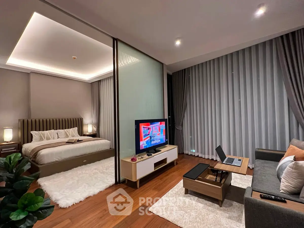 Luxurious modern living room with adjacent bedroom, featuring elegant decor and ambient lighting.