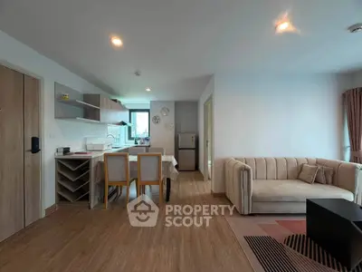 Spacious open-plan living room with modern kitchen and cozy seating area