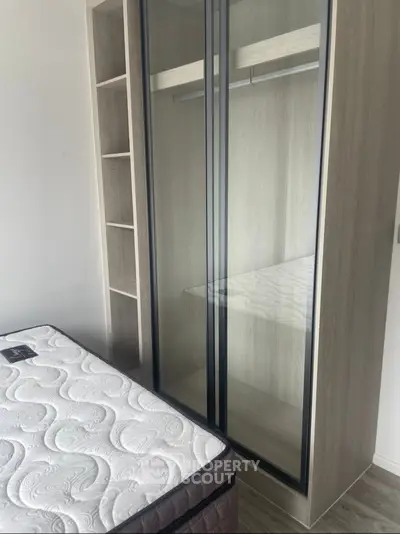 Modern bedroom with sleek wardrobe and comfortable mattress, perfect for urban living.