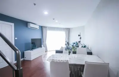 Spacious modern living room with dining area and natural light