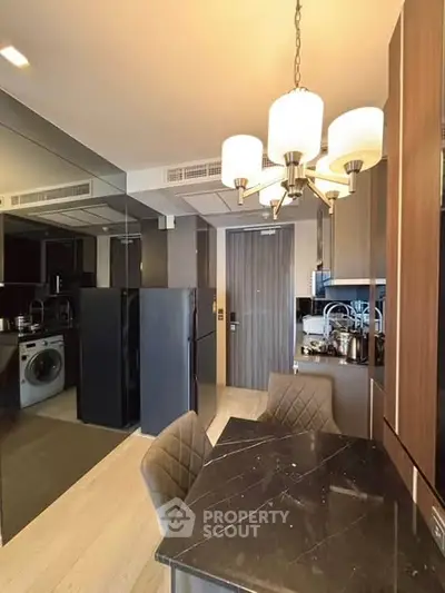 Modern kitchen with sleek appliances and elegant dining area