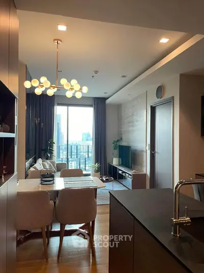 Modern living room with city view, stylish lighting, and elegant decor in a high-rise apartment.