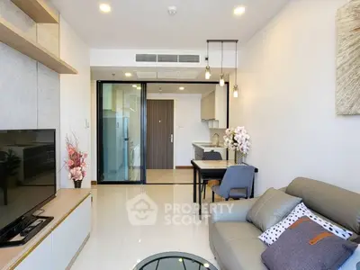 Modern living room with stylish decor and open kitchen layout in a contemporary apartment.