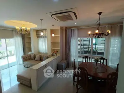 Elegant living and dining area with modern lighting and cozy seating