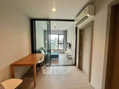 Modern apartment interior with open layout and city view, featuring a cozy living area and dining space.
