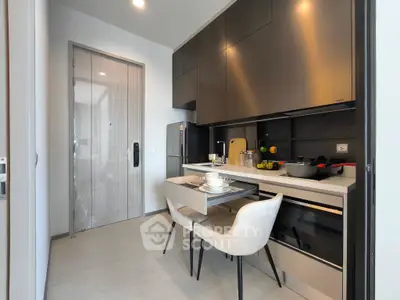 Modern kitchen with sleek cabinetry and dining area in a stylish apartment