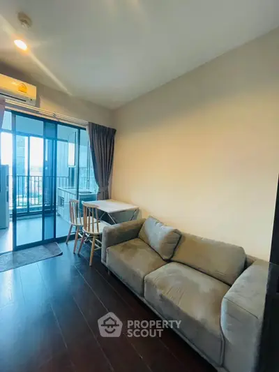 Modern living room with cozy sofa and balcony view in high-rise apartment