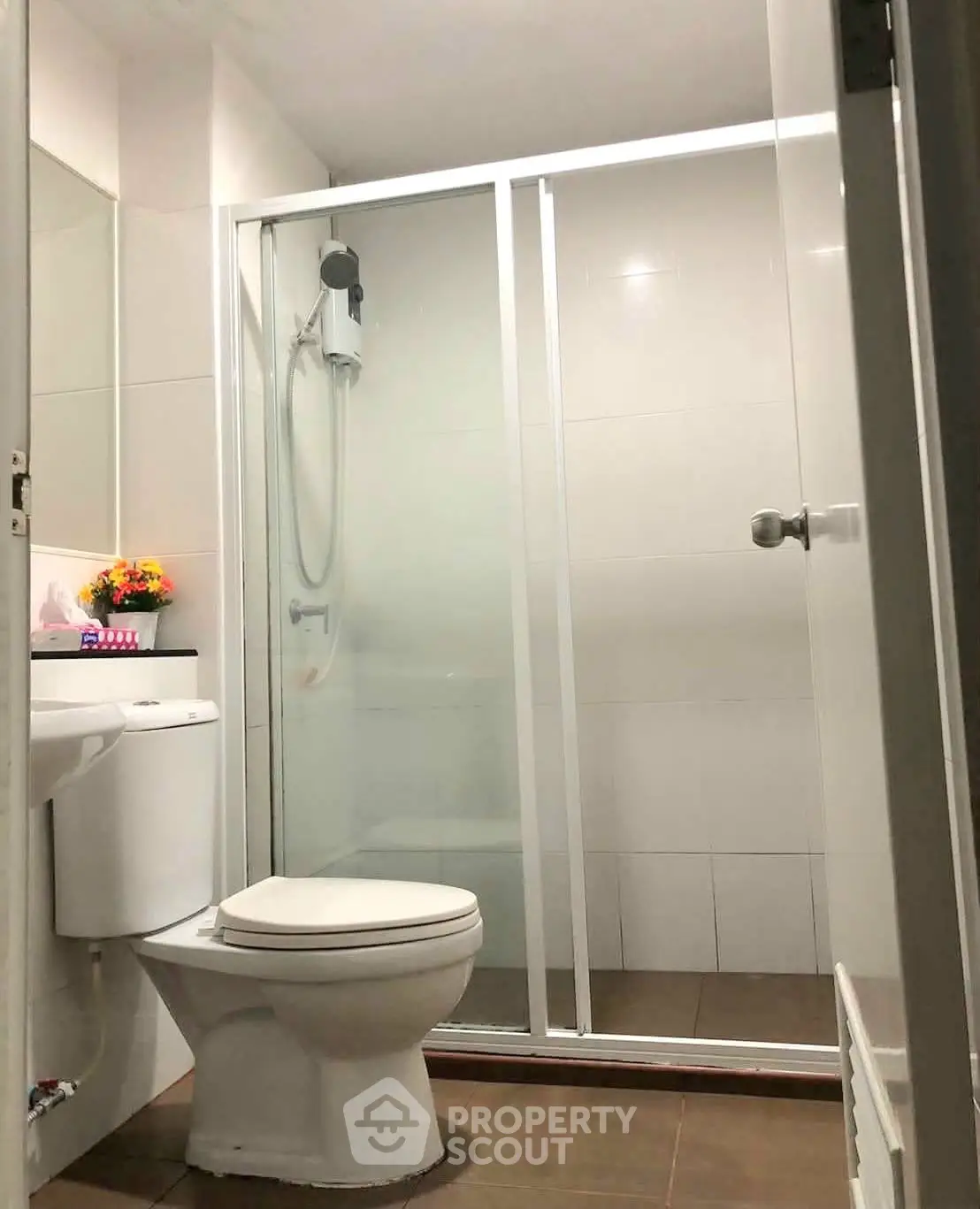 Modern bathroom with glass shower enclosure and sleek fixtures