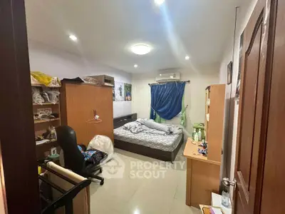 Cozy bedroom with modern furnishings and ample storage space.