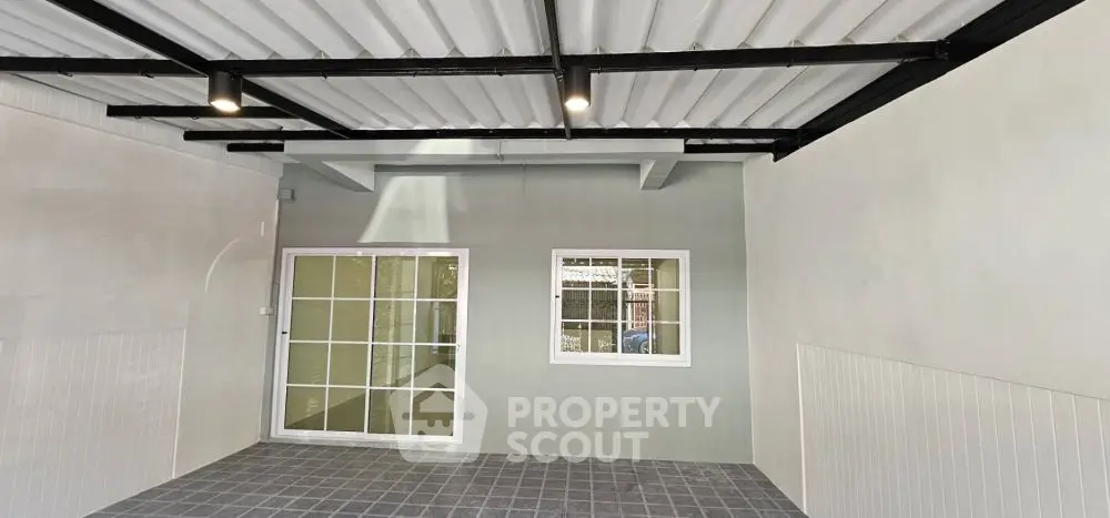 Modern garage with tiled floor and sliding glass doors