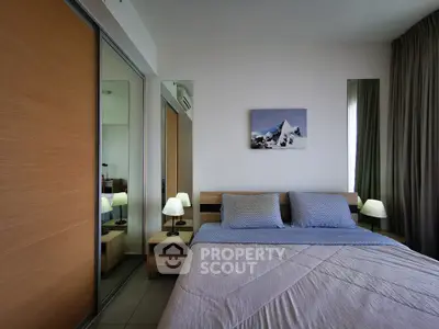 Modern bedroom with mirrored closet and stylish decor in a cozy apartment.