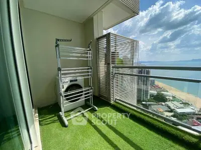 Stunning high-rise balcony with ocean view and laundry area, perfect for urban living.