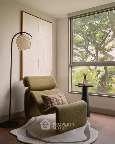 Stylish modern living room corner with designer chair and large window view.