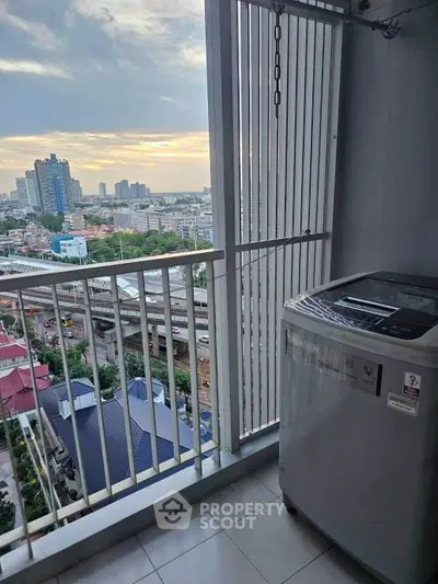 High-rise balcony with city view and washing machine, perfect for urban living.