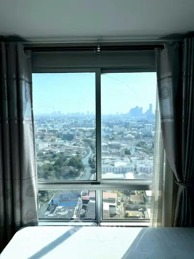 Stunning cityscape view from a high-rise apartment window, offering a serene and panoramic urban experience.