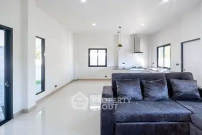 Spacious modern living room with sleek kitchen and plush sofa