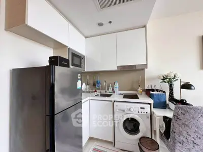 Modern compact kitchen with sleek appliances and stylish decor