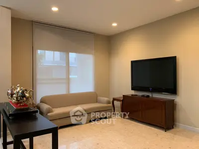 Elegant living room with modern decor and mounted TV, perfect for relaxation.