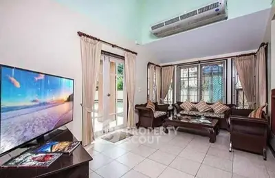 Spacious living room with modern decor and large windows for natural light.