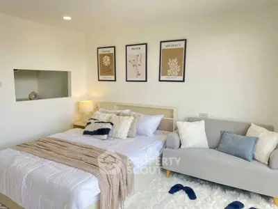 Cozy bedroom with modern decor, plush bedding, and stylish wall art, perfect for relaxation and comfort.