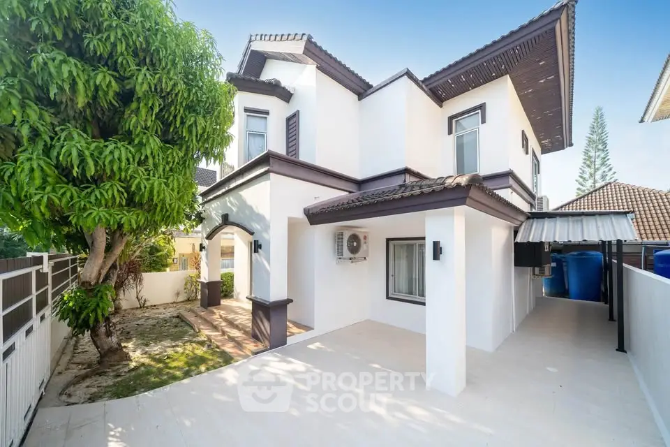 Stunning modern two-story house with spacious driveway and lush greenery, perfect for family living.