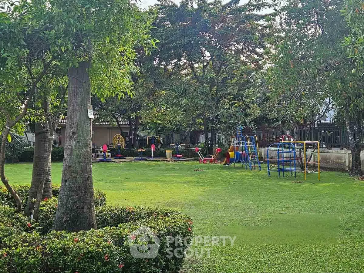 Charming residential playground surrounded by lush greenery, perfect for family-friendly living.