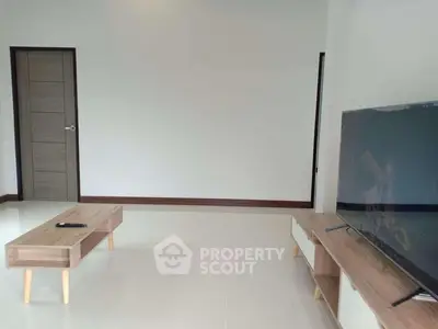 Modern living room with sleek furniture and large TV setup