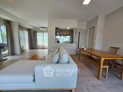 Spacious modern living room with large windows and elegant furniture