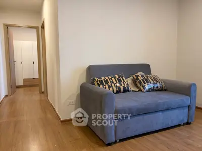 Cozy living room with stylish sofa and wooden flooring in modern apartment