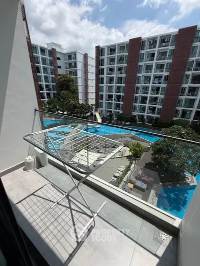 Modern apartment balcony with pool view in urban residential complex