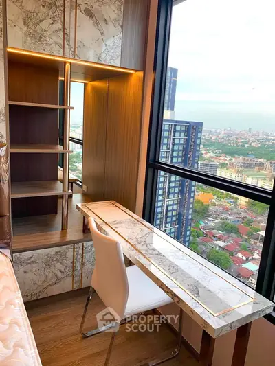 Luxurious study area with marble desk and stunning city view in high-rise apartment.