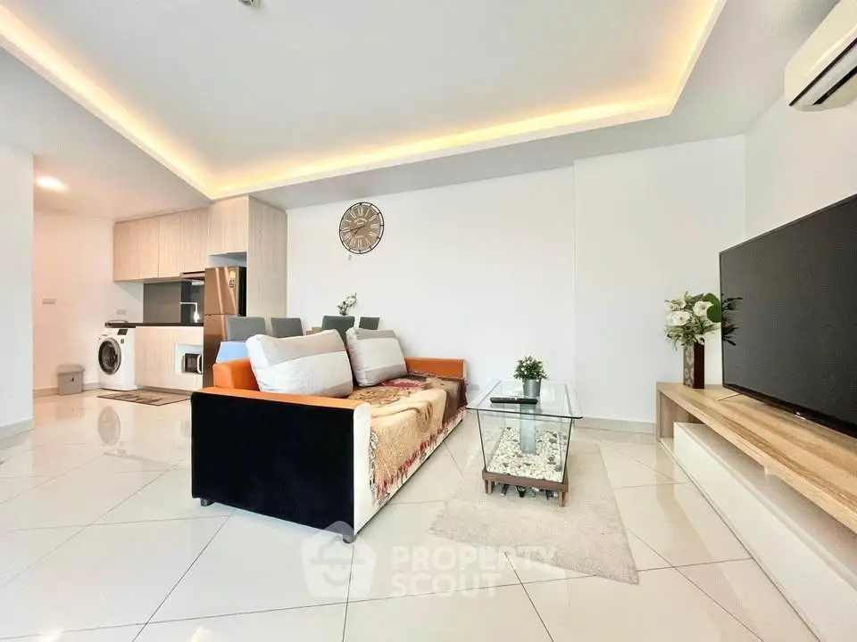 Spacious modern living room with open kitchen and sleek design