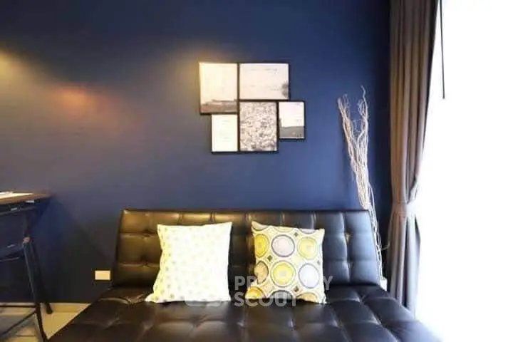 Stylish modern living room with dark blue accent wall and chic decor