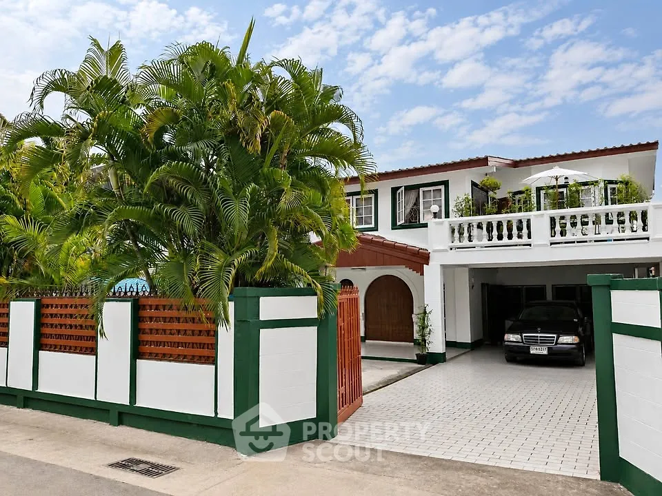 Charming two-story house with lush garden and spacious driveway in a serene neighborhood.