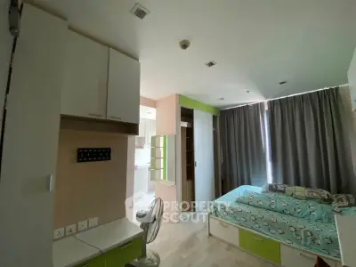 Cozy bedroom with modern furniture and natural light in a stylish apartment.