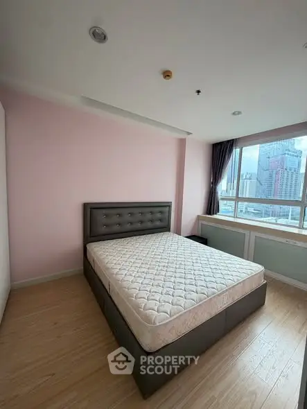 Spacious bedroom with city view and modern furnishings
