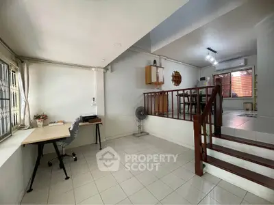 Spacious split-level living area with modern decor and natural light