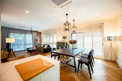 Spacious open-plan living and dining area with elegant decor and natural light.