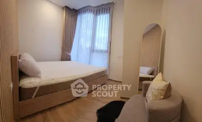Modern bedroom with large windows and cozy decor in a stylish apartment.